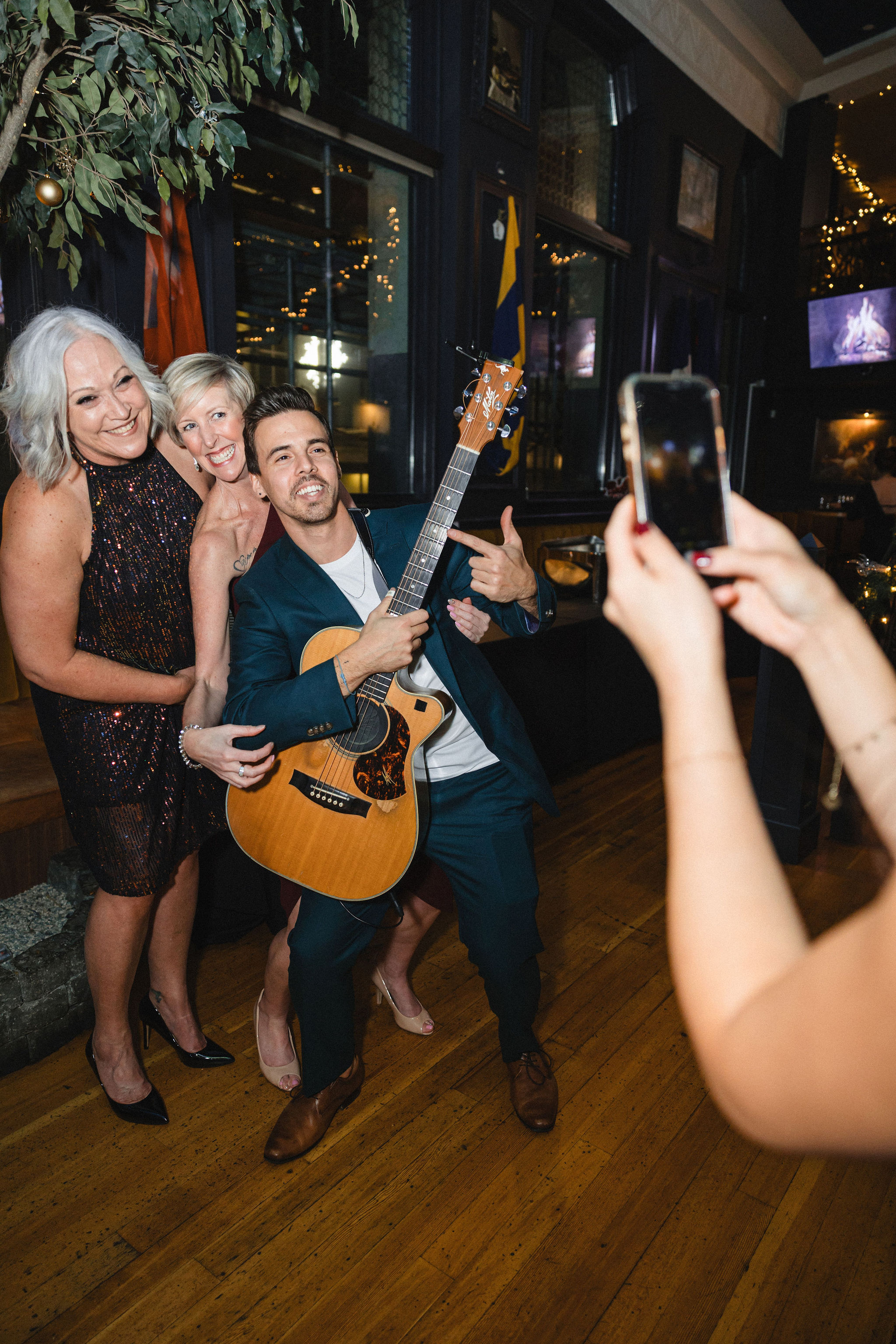 Guests taking photos with Lenny at a corporate holiday party