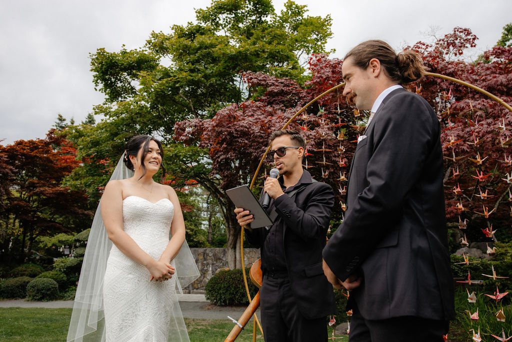 The couple smiling during the ceremony